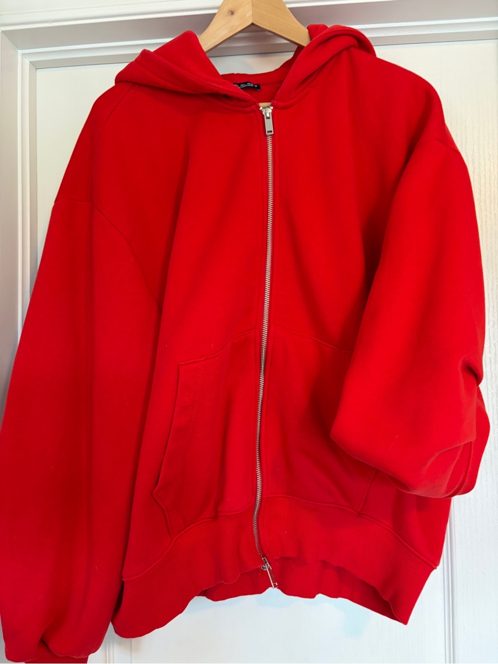 Red fleece-lined jacket interior with Zara label